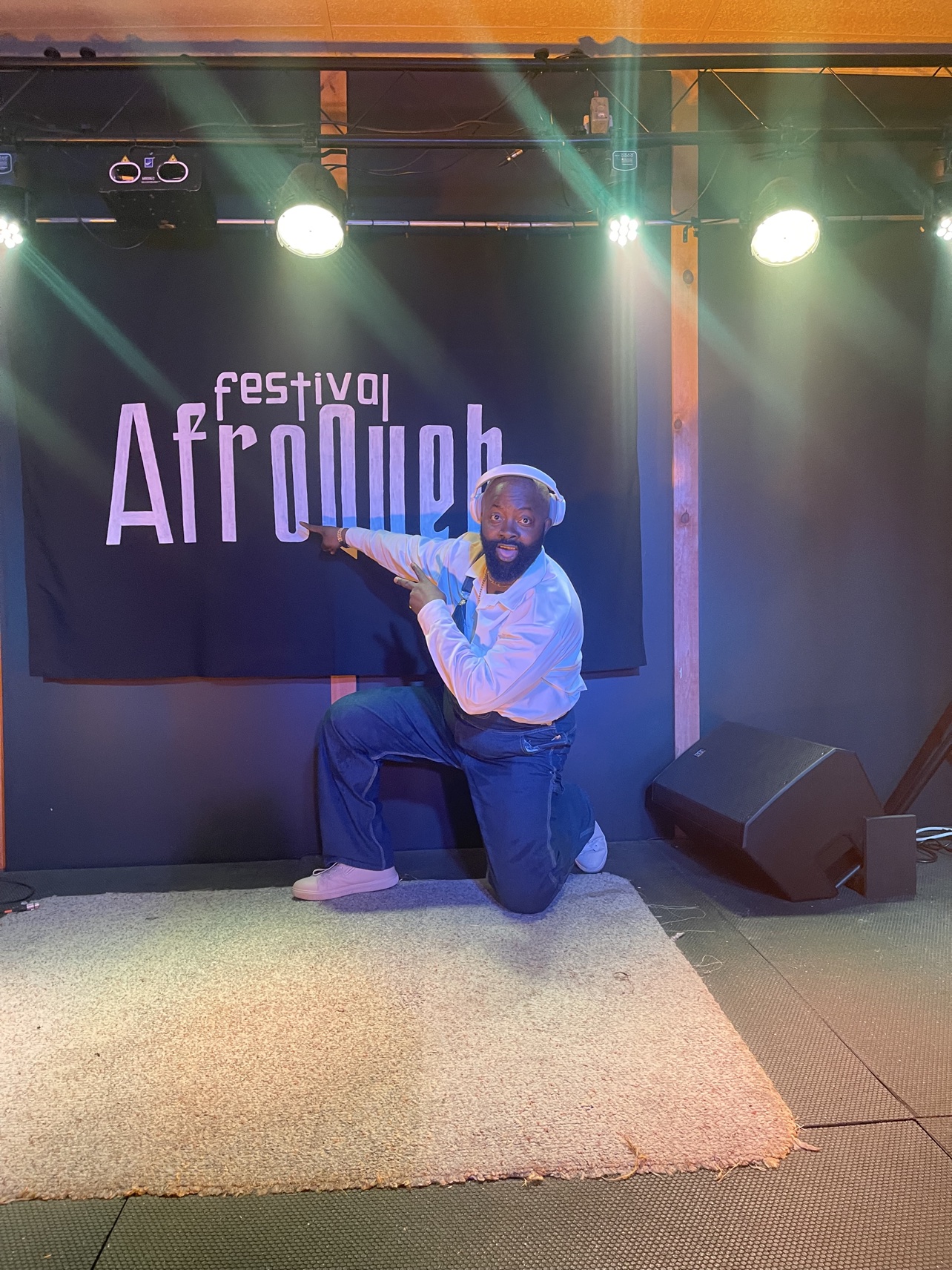 Moïse 1er in front of the banner of the AfroQueb Festival