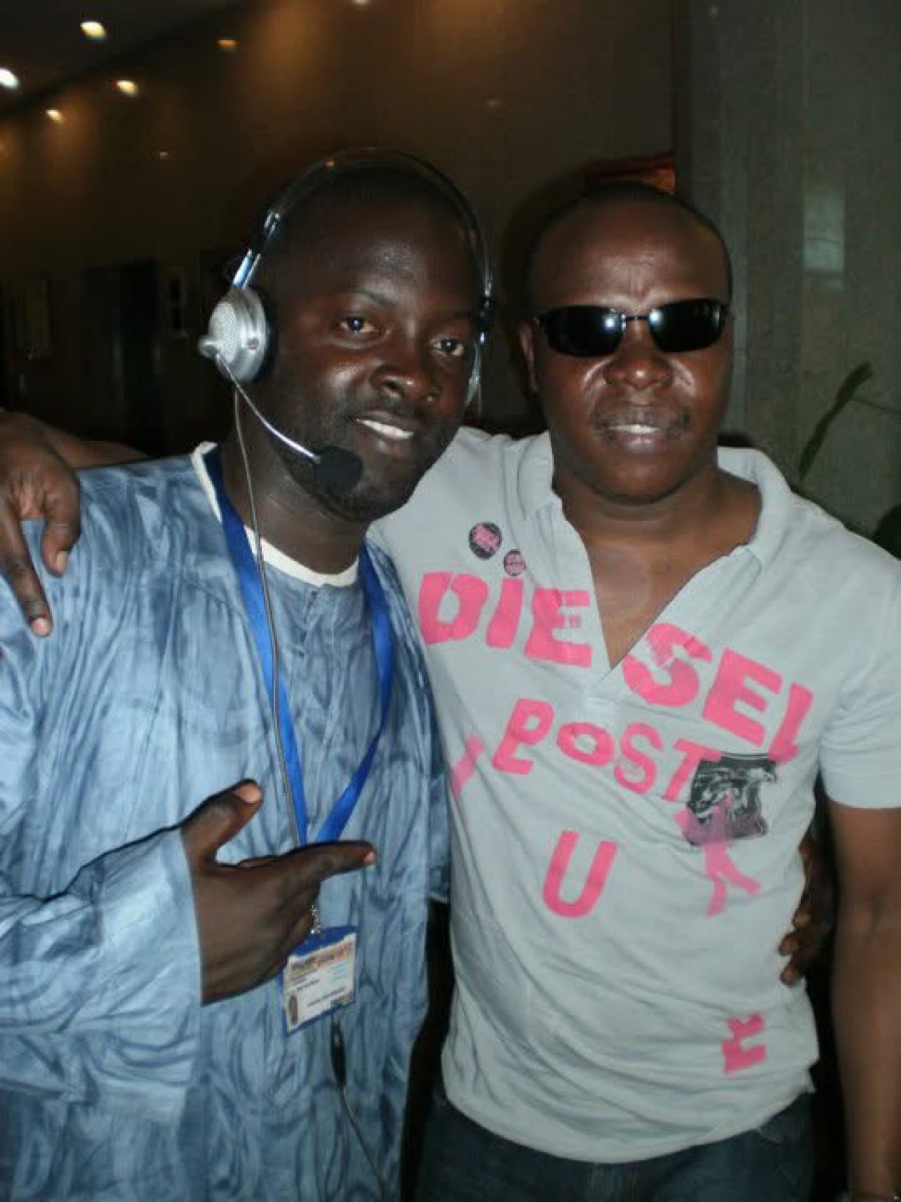 En coulisses à Conakry : Moïse, casque-micro et badge presse, aux côtés d'un artiste du projet — Projet Tous Ensemble. © Festival TV / Moïse 1er