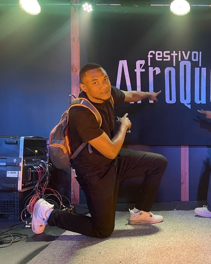 Biro Kanté, co-founder of Festival TV , in front of the official painting of the AfroQueb Festival in Quebec City