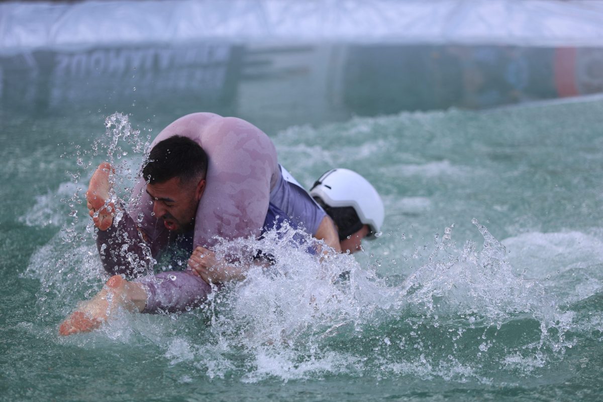A couple in full splash in the water barrier of the Eukonkanto, edition 2025