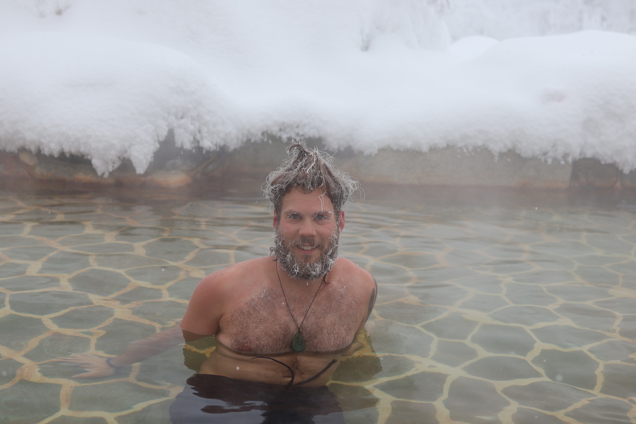 A participant in the beard and frosted hair, in a hot spring basin Eclipse