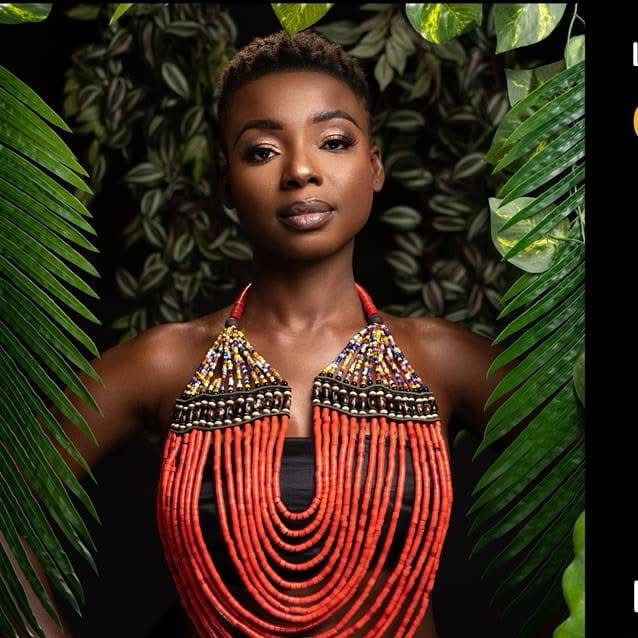 Kandy Guira, official portrait — red bead necklace