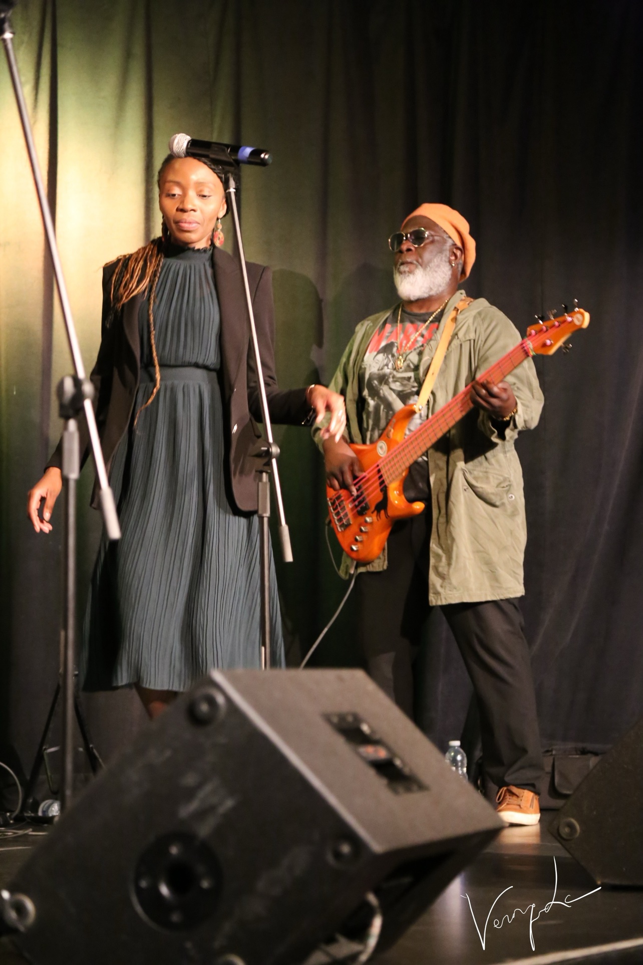 The singer on the microphone, accompanied by the bassist