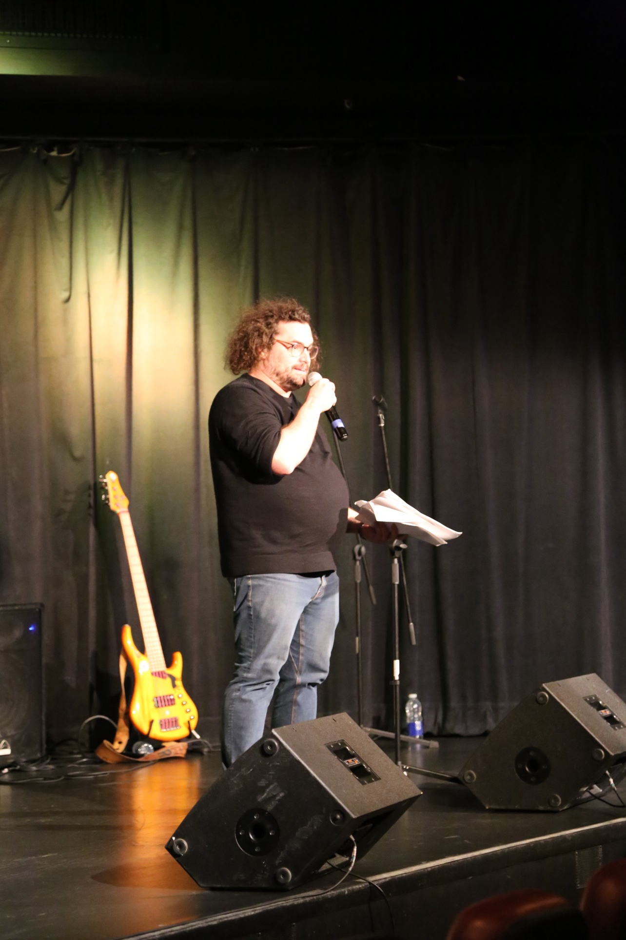 The single slammer on stage, microphone and handwritten texts