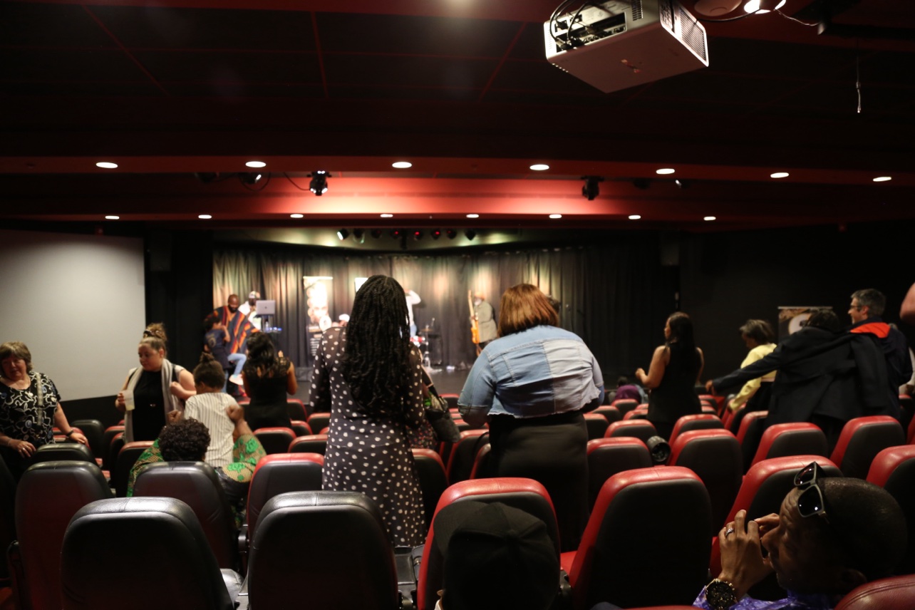 The audience standing in the room