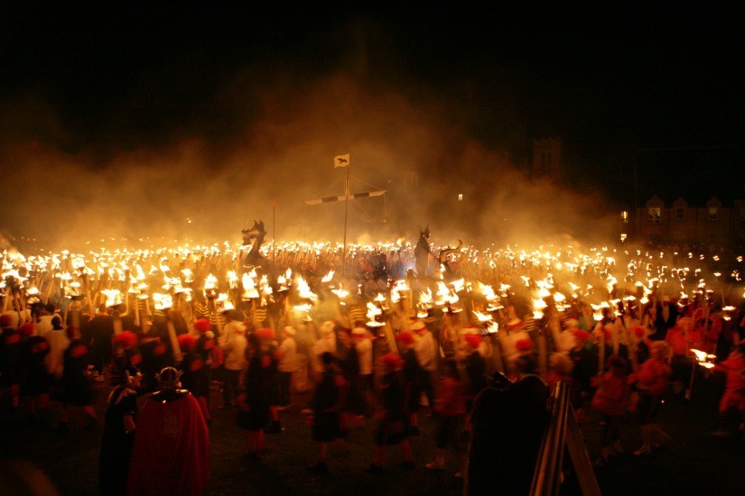 The guizers form a circle around the galley before it is burned.