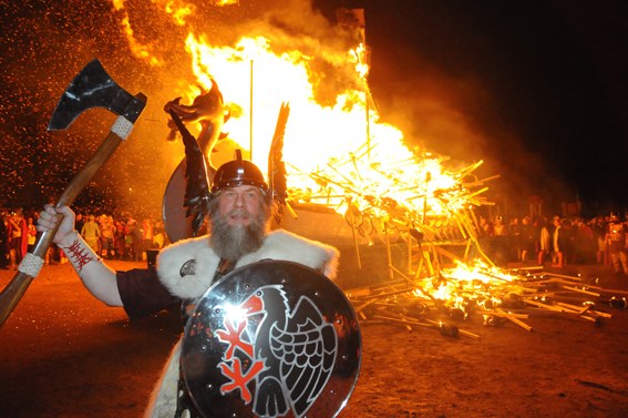 Guizer Jarl Stephen Mouat in front of the burning galley, 2009